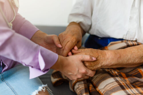 holding elderly hands