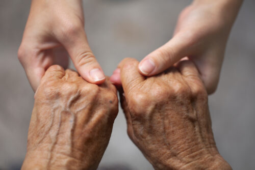 holding elderly hands
